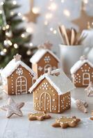 Gingerbread house decorations and star cookies displayed in a cozy holiday setting photo