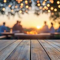 Evening gathering around a fire with string lights illuminating the outdoor setting at dusk photo