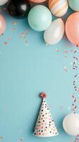 Colorful party decoration with balloons, confetti, and a party hat against a light blue background photo