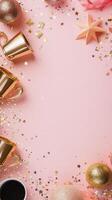 Celebratory gold cups and colorful confetti on a pastel pink background for a festive occasion photo