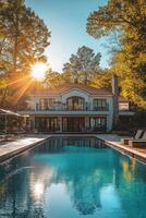 Elegant villa with a pool surrounded by trees during sunset in a serene location photo