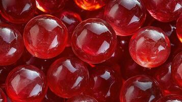 Red glass marbles scattered on a blurred backdrop with bright bokeh effects during daylight photo