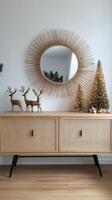 A festive corner with a stylish cabinet, Christmas tree, and winter reindeer figures photo