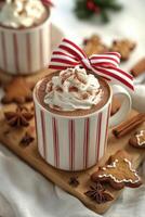 A cozy holiday hot chocolate served with whipped cream and gingerbread cookies on a festive table photo