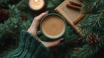 Cozy winter evening with a warm drink, reading a book, surrounded by natures decorations photo