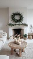 Modern living room with a cozy fireplace decorated for winter with candles and greenery photo