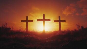 Three crosses silhouetted against a vibrant sunset on a serene landscape photo