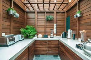 Modern outdoor kitchen featuring toasters, blender, and kettle in wooden setting photo