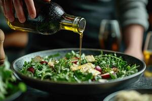 Chef pouring olive oil over fresh arugula salad with grilled halloumi and radish photo