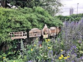 A fence with a bunch of different bird houses on it photo
