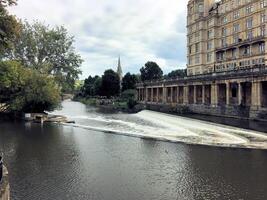 A boat is traveling down a river with a building in the background photo