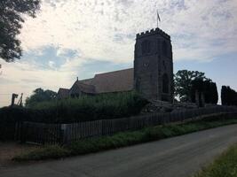A church with a steeple and a fence photo