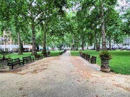 A park with benches and trees in the middle of it photo