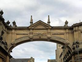 A stone archway with a clock tower on top photo