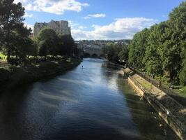 A river with a bridge and trees in the background photo