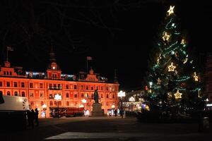 Festive Christmas Tree and Illuminated Building in Sundsvall, Sweden photo