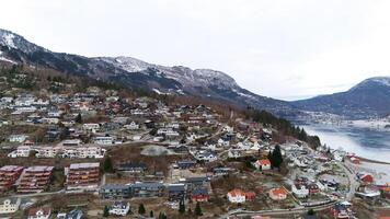 Hillside Homes in Norway Overlooking a Tranquil Fjord and Snowy Mountains photo