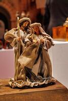 A nativity scene showcases a collection of figures, including shepherds, angels, and the three Magi, gathered around baby Jesus in a manger photo