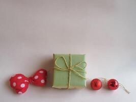 Christmas gifts and decorations on a minimalist pastel pink background. photo