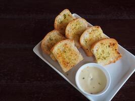 Delicious garlic bread at a cafe on a wooden table photo