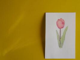 Drawing pastel minimalist pink tulips on paper with yellow background about art education photo