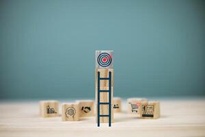 Stairs leading to target board on square wooden blocks. Planning and setting goals concept. photo