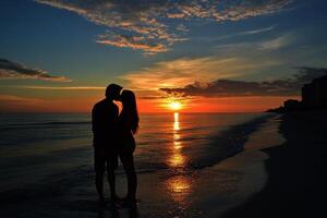 Perfect scene for Valentines Day with the silhouette of kissing on the beach with beautiful sunset in background. photo