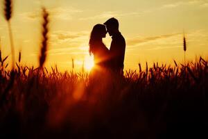 couple shares an intimate moment in wheat field at sunset capturing the essence of love and connection. photo