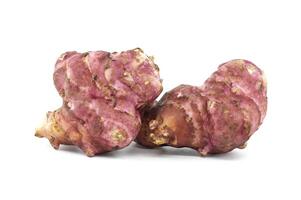 Close-Up of Fresh Pink Jerusalem Artichokes on White Background photo