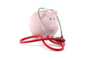 Piggy Bank With Stethoscope Representing Financial Health And Savings photo