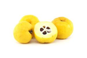 Japanese quince fruit in vibrant yellow, featuring whole and halved views isolated on white photo