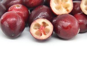 Fresh Red Cranberries With Cross-Sectional View On White Background photo