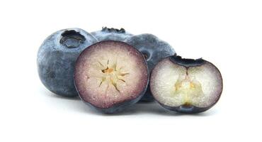 Fresh Blueberries Piled with Juicy Halved Slices Isolated on White Background photo