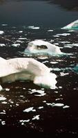 A serene landscape with floating icebergs in the water video