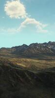 A majestic mountain range with wisps of clouds floating in the sky video