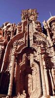 A towering building adorned with intricate statues on its walls video