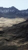A view of a mountain range from the top of a hill video