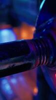 A close up of a metal object with neon lights in the background video