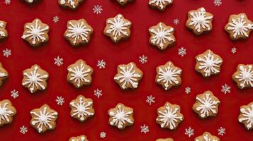 Christmas gingerbread cookies with snowflakes on red background. Top view. photo