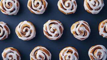 Pattern of cinnamon rolls on blue background. Top view. photo