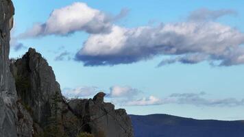 Aerial view of the top of a rocky mountain on a background of clouds video