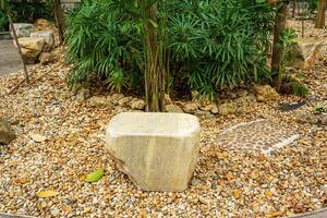 A large stone made into a chair to decorate the garden. photo