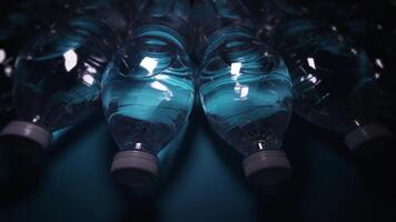 row of bottles with water at light rays on dark background video