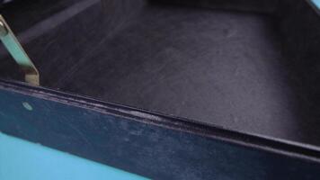 open leather case with handle and digital lock on light blue video