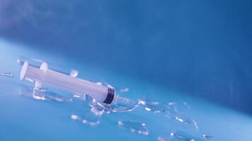 Syringe falls in slow motion in the middle of the broken glass video