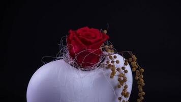 Red rose spins in the white vase video