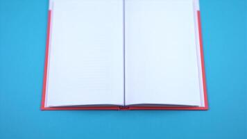 Open book with empty pages on a blue background video