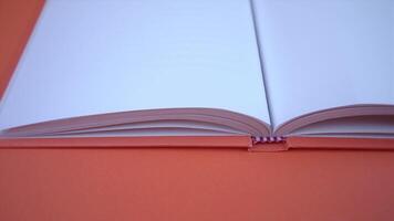 Open book with empty pages on orange background video