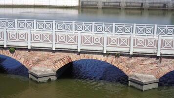 empty retro bridge with handrails over river on summer day video
