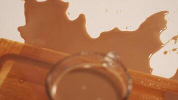 delicious coffee with milk spilled on white table and board video